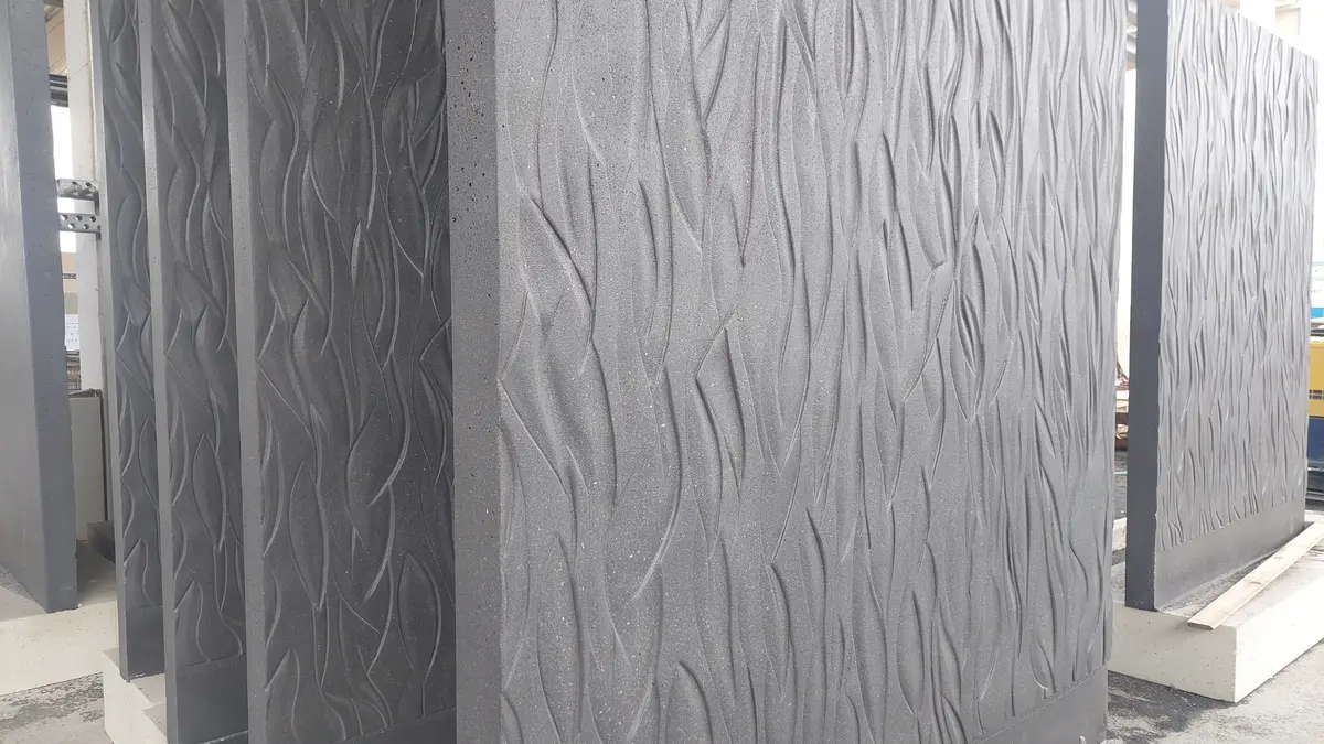 The precast concrete elements feature an organic relief texture with precisely crafted design elements.