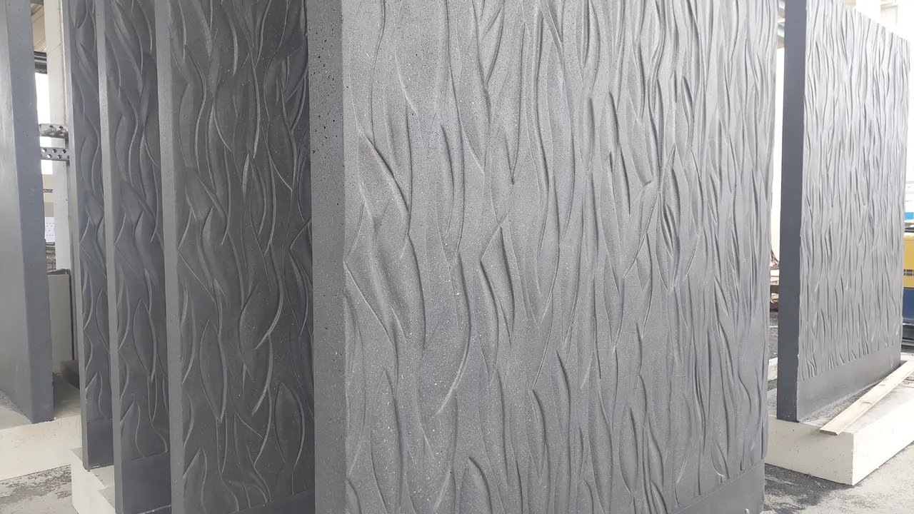 The precast concrete elements feature an organic relief texture with precisely crafted design elements.