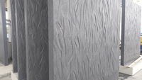 The precast concrete elements feature an organic relief texture with precisely crafted design elements.