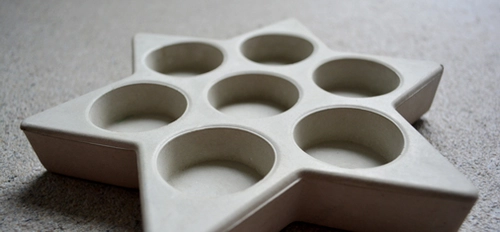 Because of its fine, aesthetically attractive surface quality and easy workability, Emcekrete 70 F is ideally suited to the manufacture of small crafted concrete products such as the tea light holder and wardrobe element illustrated here. <br>&copy; MC-Bauchemie 2026