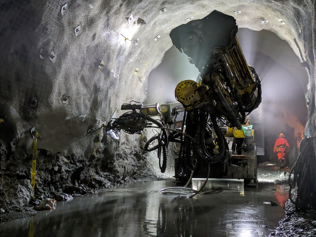 A drilling machine in action during conventional tunnel construction.